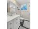 Modern bathroom with white vanity, large mirror, and walk-in shower at 8911 Blind Pass Rd # 305, St Pete Beach, FL 33706