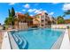 Inviting community pool with plenty of lounge chairs at 8911 Blind Pass Rd # 305, St Pete Beach, FL 33706