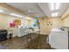 Clean and well-maintained laundry room with seating at 8911 Blind Pass Rd # 305, St Pete Beach, FL 33706