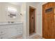 Bathroom with white vanity, shower, and sauna at 8911 Blind Pass Rd # 305, St Pete Beach, FL 33706