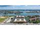 Aerial view of waterfront community with lush landscaping and boat docks at 8911 Blind Pass Rd # 305, St Pete Beach, FL 33706