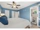 Spacious bedroom with ensuite bathroom and ceiling fan at 8911 Blind Pass Rd # 305, St Pete Beach, FL 33706