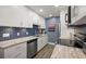 Modern kitchen featuring stainless steel appliances and blue tile backsplash at 8911 Blind Pass Rd # 305, St Pete Beach, FL 33706