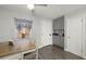 Cozy dining area adjacent to kitchen, featuring wood table and gray cabinets at 8911 Blind Pass Rd # 305, St Pete Beach, FL 33706