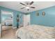 Bright bedroom with mirrored closet doors and ceiling fan at 8911 Blind Pass Rd # 305, St Pete Beach, FL 33706