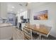 Kitchen and dining area with wood table and chairs, beach-themed decor at 8911 Blind Pass Rd # 305, St Pete Beach, FL 33706