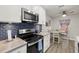 Updated kitchen with white cabinets and blue tile backsplash at 8911 Blind Pass Rd # 305, St Pete Beach, FL 33706