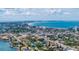 Wide aerial view of coastal town with beach and waterways at 8911 Blind Pass Rd # 305, St Pete Beach, FL 33706