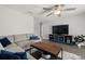 Spacious living room featuring sectional sofa, large TV, and wood coffee table at 8911 Blind Pass Rd # 305, St Pete Beach, FL 33706