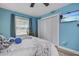 Guest bedroom with white louvered doors and blue walls at 5134 Salmon Se Dr # A, St Petersburg, FL 33705