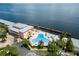 Resort-style pool with waterfront views; community clubhouse in background at 5134 Salmon Se Dr # A, St Petersburg, FL 33705