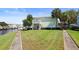 Waterfront property with lush lawn, walkway, and two-story building at 5134 Salmon Se Dr # A, St Petersburg, FL 33705