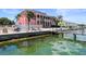 Pink building with a pool and private dock on the water at 5134 Salmon Se Dr # A, St Petersburg, FL 33705