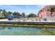 Community pool with sun loungers and waterfront views at 5134 Salmon Se Dr # A, St Petersburg, FL 33705