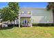 Two-story building with balcony, waterfront view, and lush landscaping at 5134 Salmon Se Dr # A, St Petersburg, FL 33705