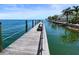 Long wooden community dock extending into calm water at 5134 Salmon Se Dr # A, St Petersburg, FL 33705