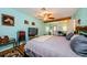 Main bedroom with a view of the backyard, wood floors, and ceiling fan at 2208 Citrus Valley Cir, Palm Harbor, FL 34683