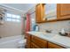 Bathroom with tub, shower, and wood vanity at 2208 Citrus Valley Cir, Palm Harbor, FL 34683