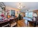 Open dining area with wood floors and view into living room at 2208 Citrus Valley Cir, Palm Harbor, FL 34683