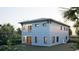 A well-lit modern home featuring a balcony, clean lines, and views of the serene backyard at 1045 Conant Ave, Safety Harbor, FL 34695