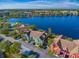 Aerial view of a townhome community with a lake; the subject property is a teal-colored building at 9028 Lake Chase Island Way, Tampa, FL 33626