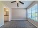 Bright bedroom featuring a ceiling fan and ensuite bathroom at 9028 Lake Chase Island Way, Tampa, FL 33626