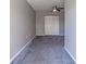 Bright bedroom featuring grey walls and carpet, plus double door closet at 9028 Lake Chase Island Way, Tampa, FL 33626