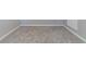 Empty bedroom with grey carpet and recessed lighting at 9028 Lake Chase Island Way, Tampa, FL 33626