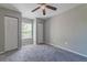 Bedroom with grey carpet, ceiling fan and double closets at 9028 Lake Chase Island Way, Tampa, FL 33626