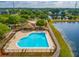 Community pool with adjacent clubhouse and lake access at 9028 Lake Chase Island Way, Tampa, FL 33626