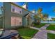 Green townhouse with walkway leading to the entrance at 9028 Lake Chase Island Way, Tampa, FL 33626
