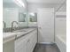Main bathroom with granite countertops, double sinks and separate tub and shower at 9028 Lake Chase Island Way, Tampa, FL 33626