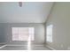 Living room with large windows, high ceilings, and wood-look floors at 9028 Lake Chase Island Way, Tampa, FL 33626