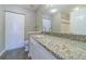 Bathroom boasts a granite countertop vanity with white cabinets at 9028 Lake Chase Island Way, Tampa, FL 33626