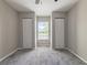 Bright bedroom with grey carpet, large window and double closets at 9028 Lake Chase Island Way, Tampa, FL 33626