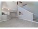Open living area with high ceilings, luxury vinyl plank flooring, and a staircase at 9028 Lake Chase Island Way, Tampa, FL 33626