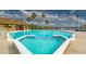 Community pool with spa and clubhouse in the background at 9028 Lake Chase Island Way, Tampa, FL 33626