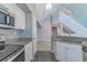 Modern kitchen with white cabinets, granite counters, and stainless steel appliances at 9028 Lake Chase Island Way, Tampa, FL 33626