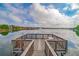 Community dock with seating area offering tranquil lake views at 9028 Lake Chase Island Way, Tampa, FL 33626