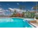 Community pool and spa with lake view and lush landscaping at 9028 Lake Chase Island Way, Tampa, FL 33626