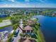 Aerial view of a townhome community with a lake; the subject property is a teal-colored building at 9028 Lake Chase Island Way, Tampa, FL 33626