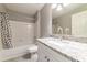 Updated bathroom with granite countertop, white vanity, and shower/tub combo at 9028 Lake Chase Island Way, Tampa, FL 33626