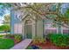 Green townhouse with private entrance and landscaping at 9028 Lake Chase Island Way, Tampa, FL 33626