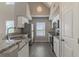 Modern kitchen with white cabinets, granite countertops, and stainless steel appliances at 9028 Lake Chase Island Way, Tampa, FL 33626