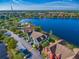 Aerial view of a townhome community with a lake; the subject property is a teal-colored building at 9028 Lake Chase Island Way, Tampa, FL 33626