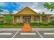 Community clubhouse with welcoming entrance and landscaping at 9028 Lake Chase Island Way, Tampa, FL 33626