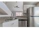 Modern kitchen with granite countertops and stainless steel dishwasher at 9028 Lake Chase Island Way, Tampa, FL 33626