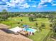 Aerial view of house, pool, and backyard; golf course in background at 10177 Sunburst Ct, Spring Hill, FL 34608