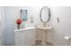Charming powder room with pedestal sink and decorative accents at 10177 Sunburst Ct, Spring Hill, FL 34608