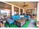 Spacious screened patio with blue sofa and fire pit at 10177 Sunburst Ct, Spring Hill, FL 34608